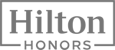 The image displays the logo of Hilton Honors, featuring the text "Hilton Honors" with a rectangular outline surrounding it.