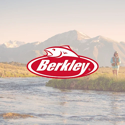 A person fishing by a river with mountains in the background, a Berkley logo centered over the scene, sunny outdoor setting.